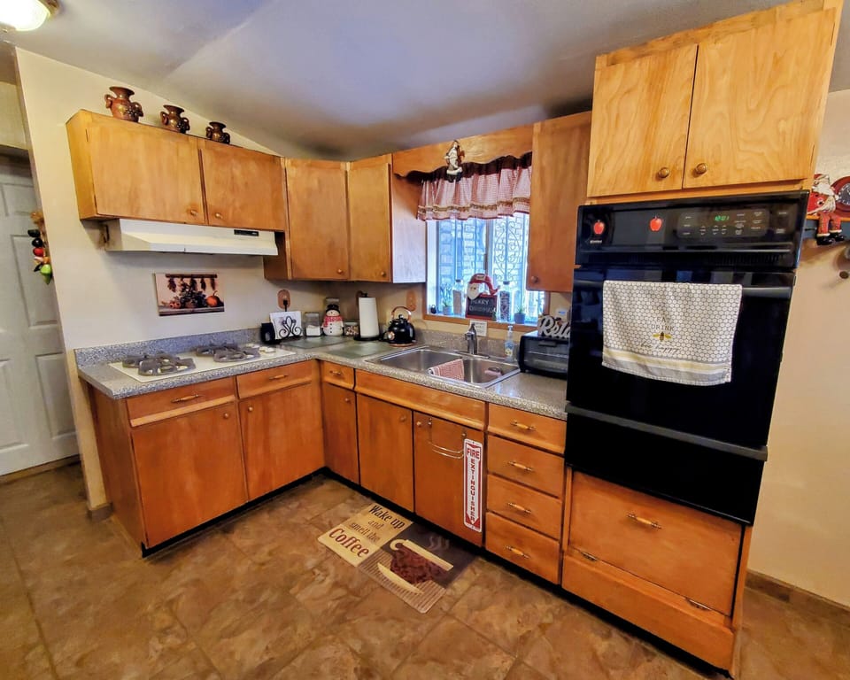 Kitchen cooking area. (gas stove, oven, dual sink)