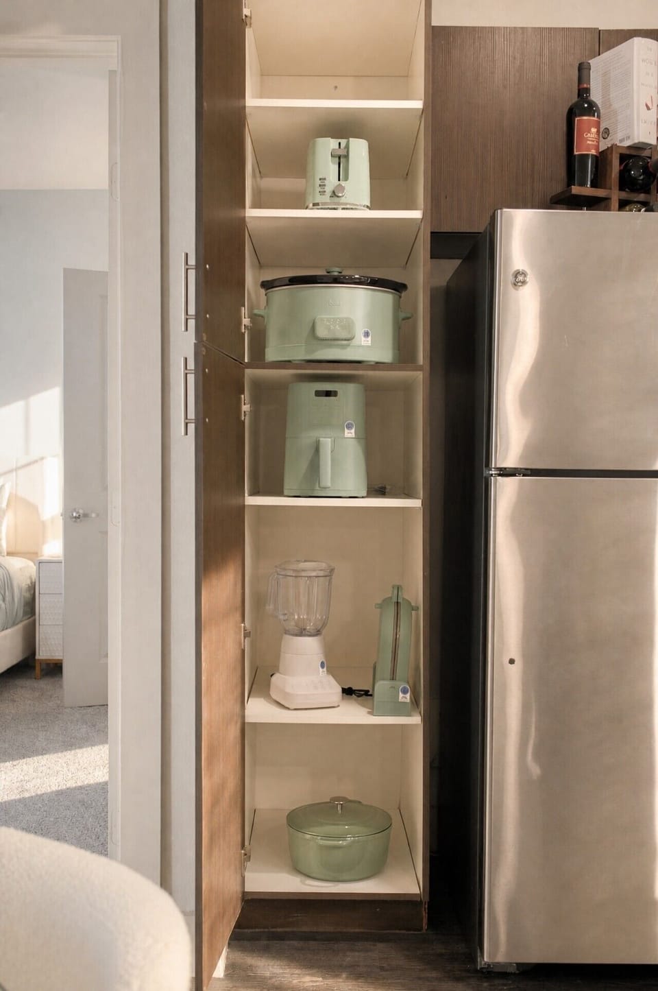 Fully stocked and organized kitchen essentials—from an air fryer to a blender, everything you need for quick snacks or homemade meals.