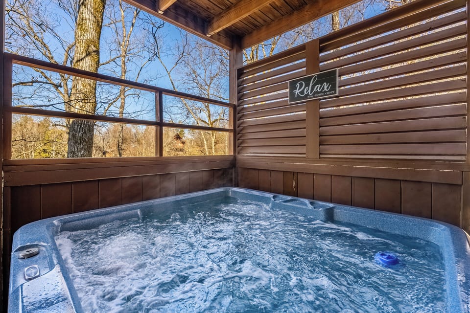 Private covered hot tub with peaceful wooded views and cozy cabin charm
