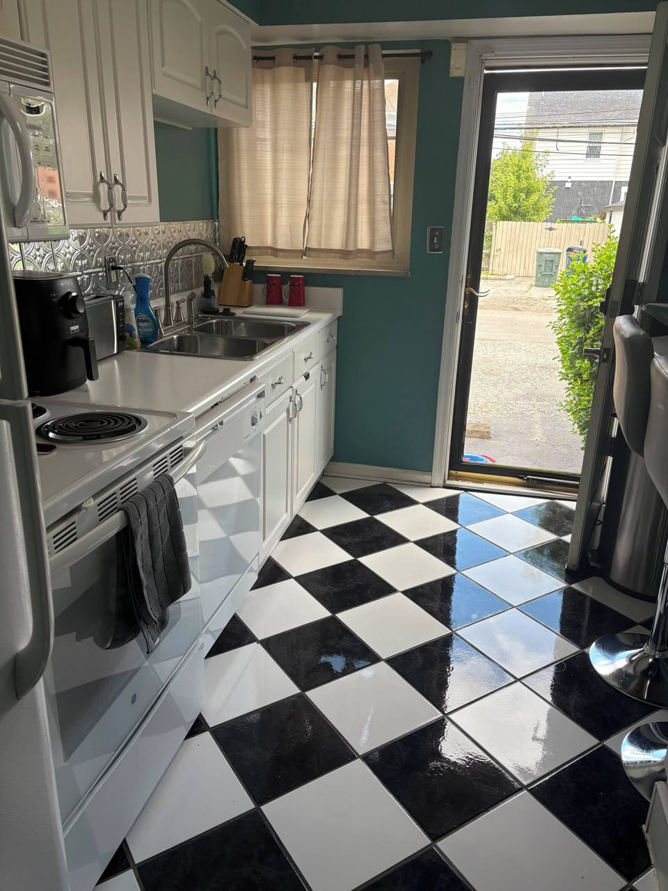 Bright retro-style kitchen with checkered floors and natural light