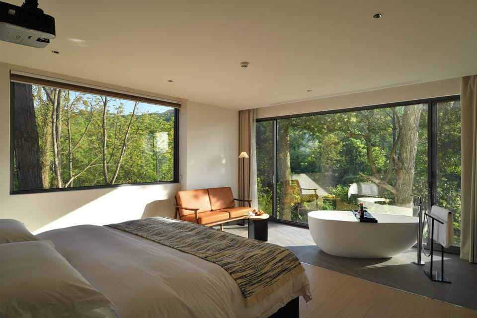 Premium bedding, desk, laptop workspace, blackout drapes