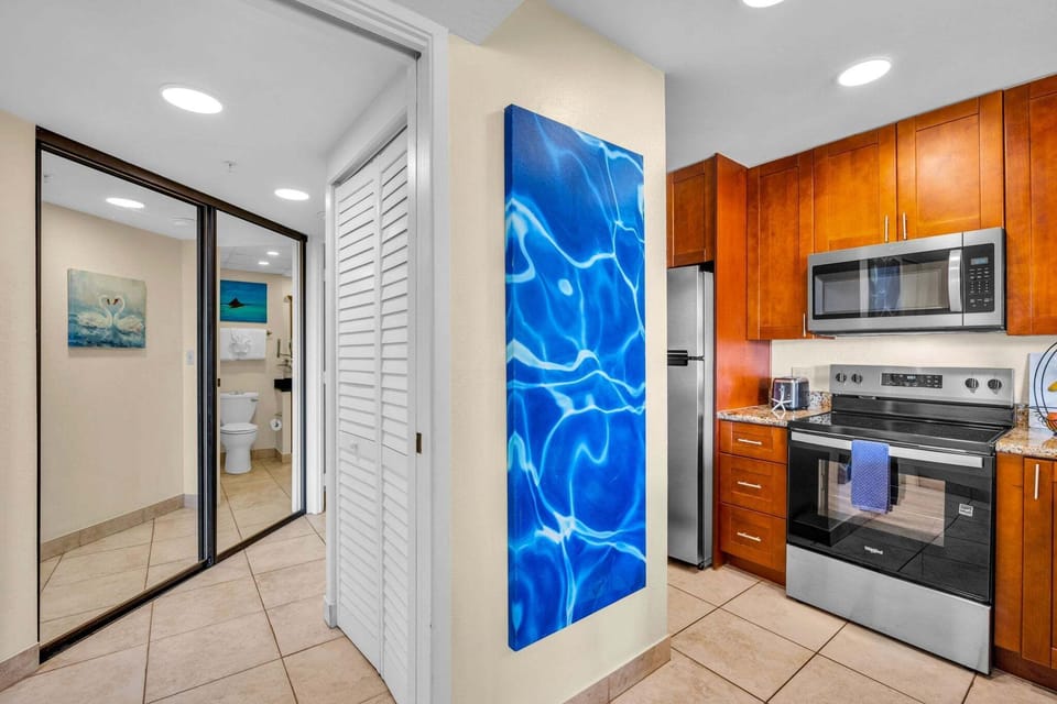 Contemporary kitchen framed by bold blue art and thoughtful details, leading seamlessly into the rest of the home.