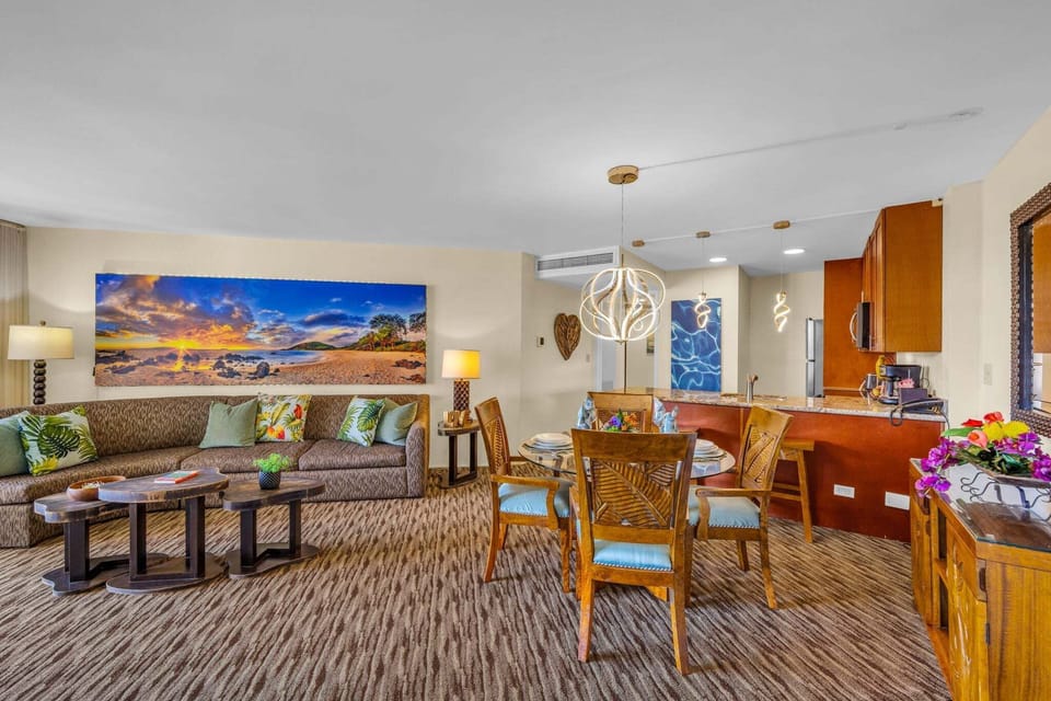 Spacious living room layered with warm light, cozy textures, and art that sets the mood for tropical escape.