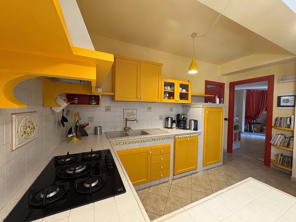 Kitchen, Kitchen Appliance, Countertop, Major Appliance, Yellow, Interior Design, Kitchen Stove, Cabinetry, Kitchen Sink, Flooring
