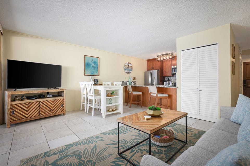 Settle into your bright, open-concept haven where coastal charm meets modern comfort. Unwind on the plush sofa, gather around the dining island, and enjoy home-cooked meals in your fully equipped kitchen—your perfect beach escape awaits.