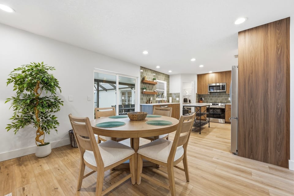 The breakfast table offers casual seating beside the kitchen.