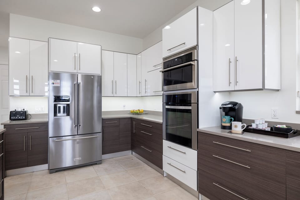Enjoy a bright and airy kitchen featuring sleek white cabinetry, modern finishes