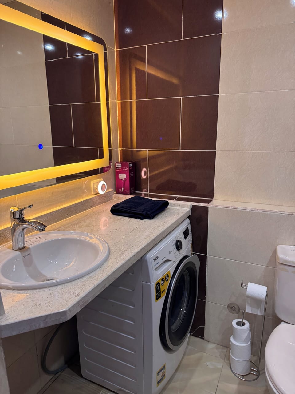 Comfortable space with washmachine and lighting mirror