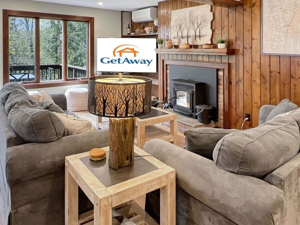 Livingroom with sofa and love seat  with fireplace and large TV