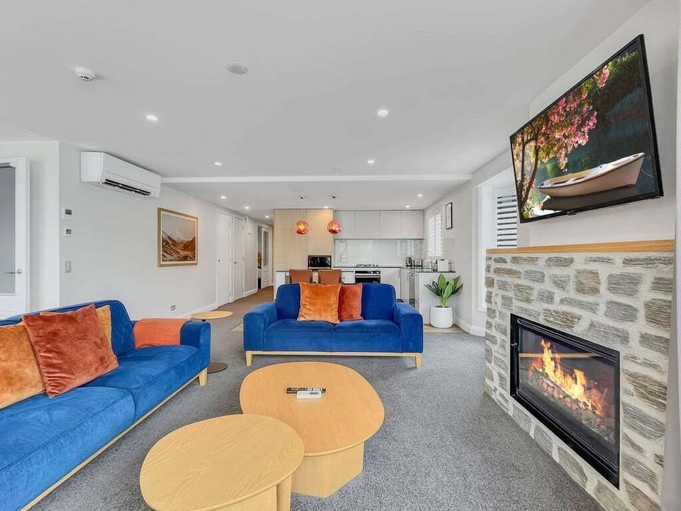 Spacious living area designed for comfort, featuring a gas fireplace, Smart TV, and open-plan layout.