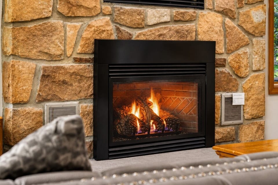 Warm fireplace creates the perfect mountain lodge atmosphere.