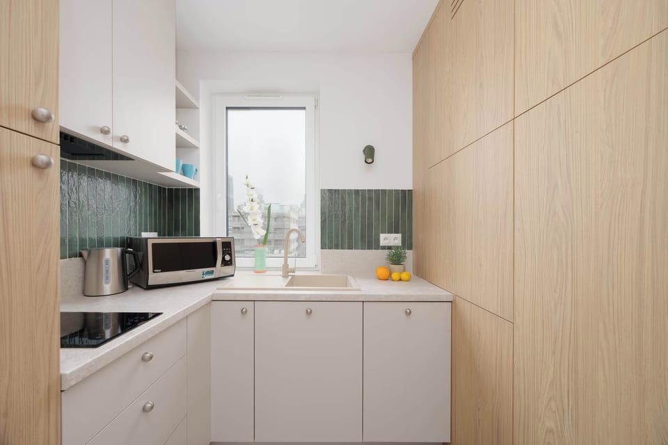 The kitchen's sleek design includes all necessary cookware and utensils.