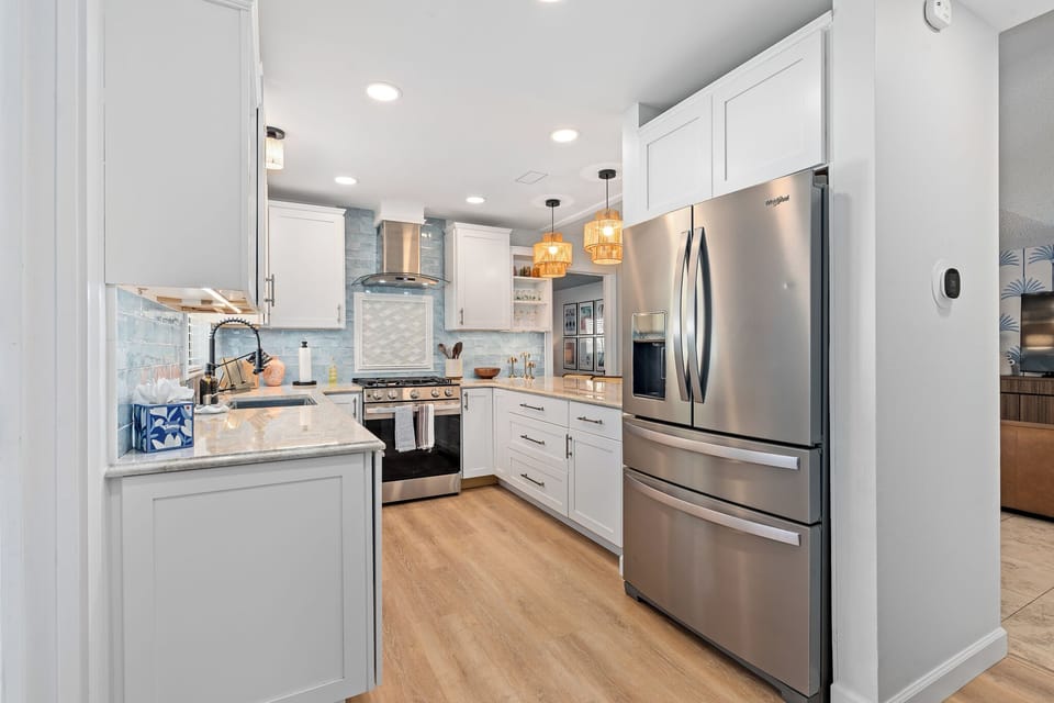 Stainless appliances, coffee bar, and space for family meals.
