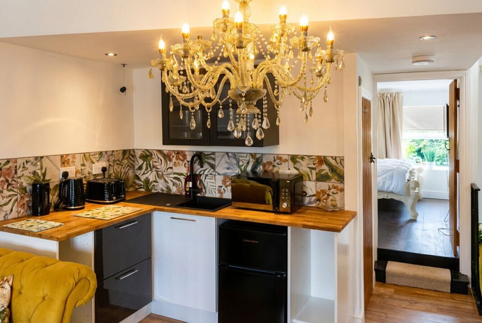 Cook beneath a golden chandelier in the fully equipped kitchen, stocked with everything you need for a relaxed stay.
