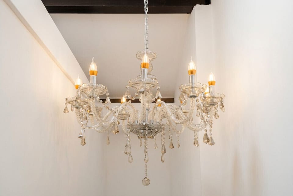 The hand-crafted crystal chandelier is a signature detail, catching the light and setting the mood throughout the stay.
