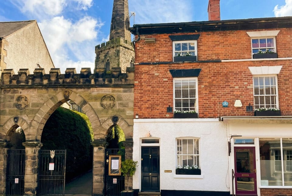Your own front door next to a medieval church arch tells the whole story of this extraordinary town-centre address.