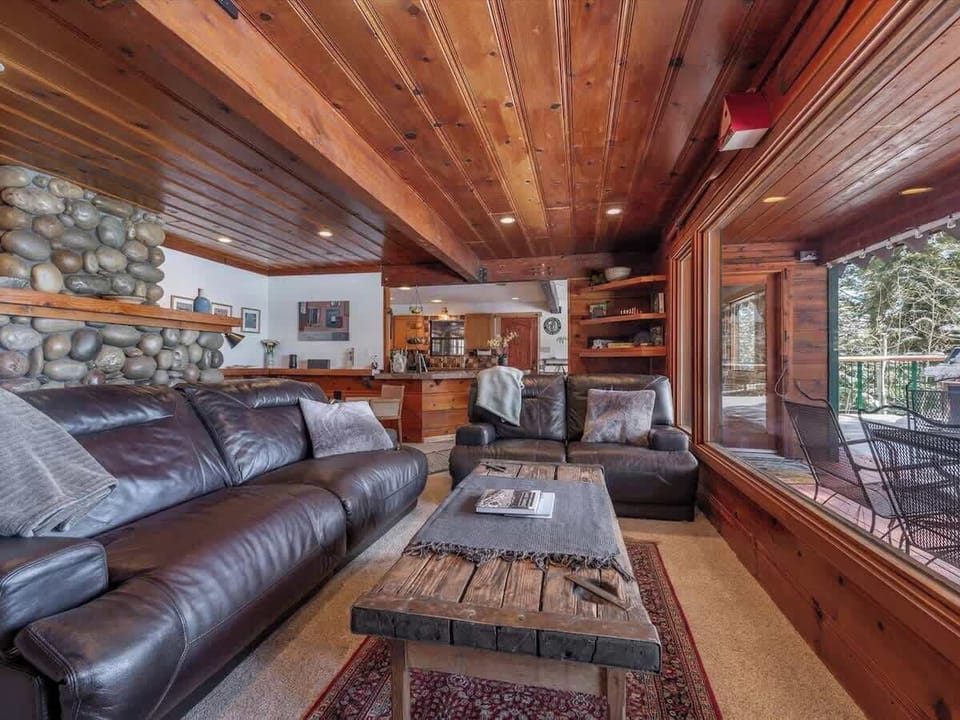 Living room: Gas fireplace, Sony Smart TV with basic cable, deck access, lake view 