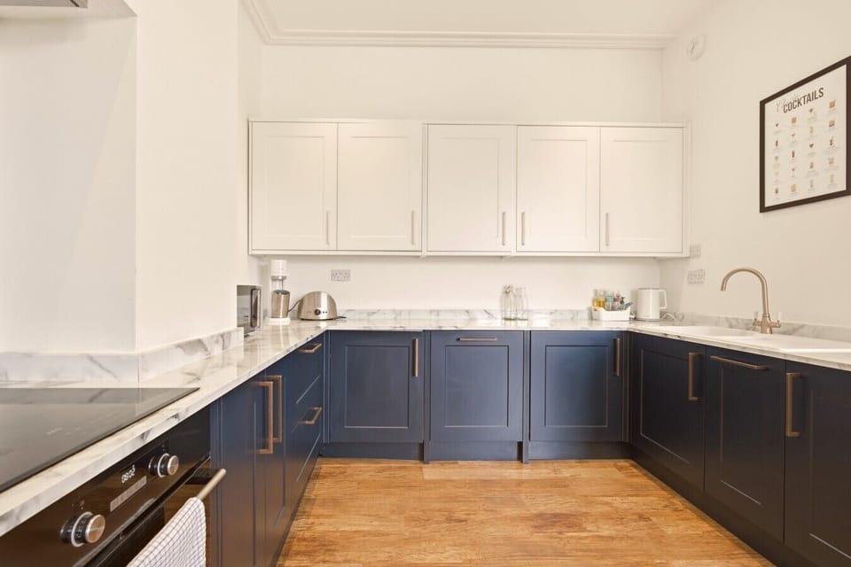 Dining area beside the modern kitchen with integrated appliances.