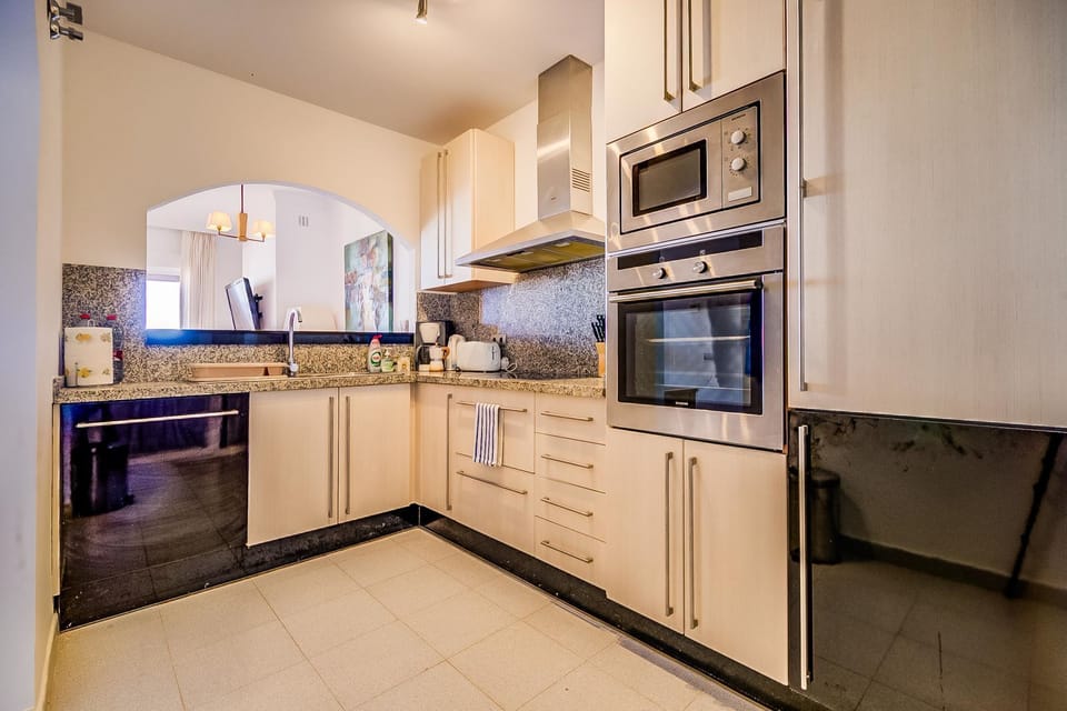 Modern fully equipped kitchen with granite counters and built-in appliances