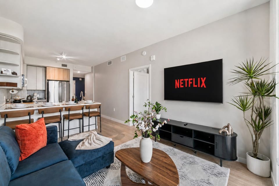 Modern open-concept living room with streaming TV and sleek breakfast bar