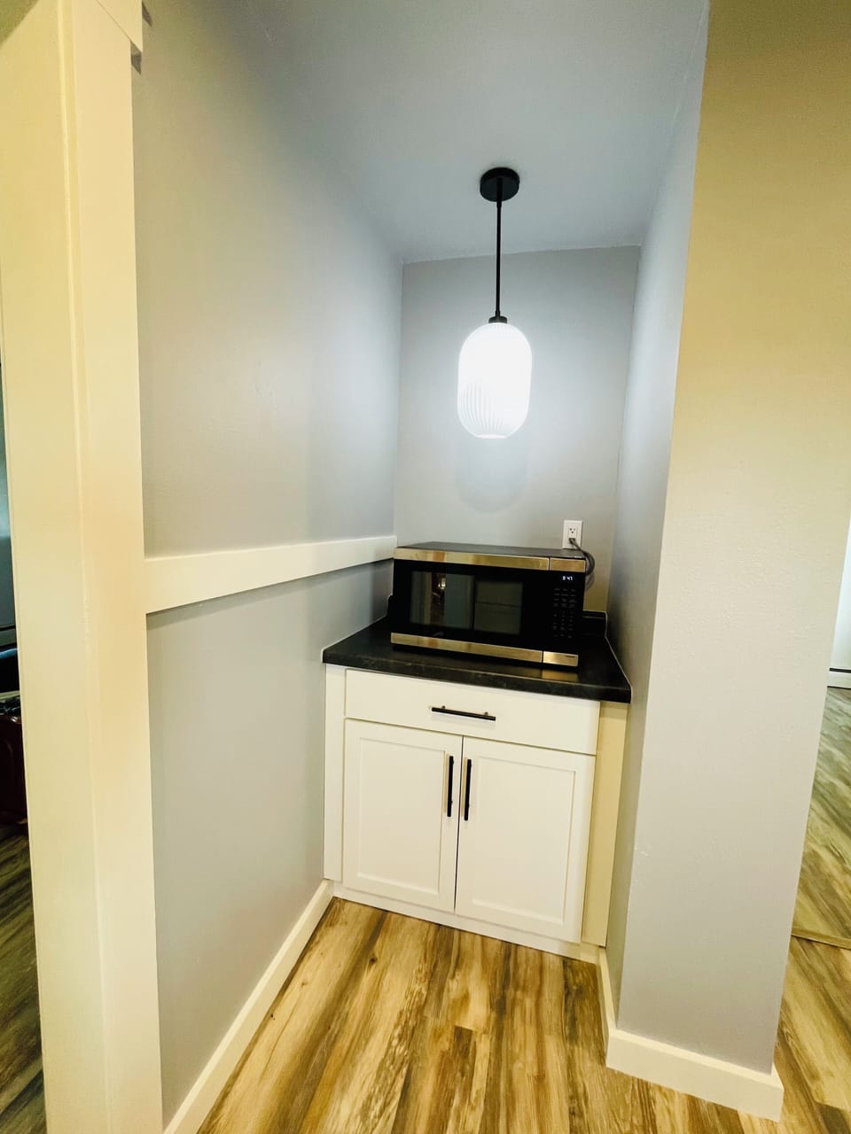 Stylish built-in microwave nook with modern lighting and extra storage