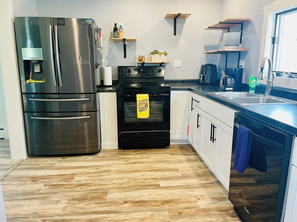 Modern kitchen with stainless appliances, coffee station, and spacious layout