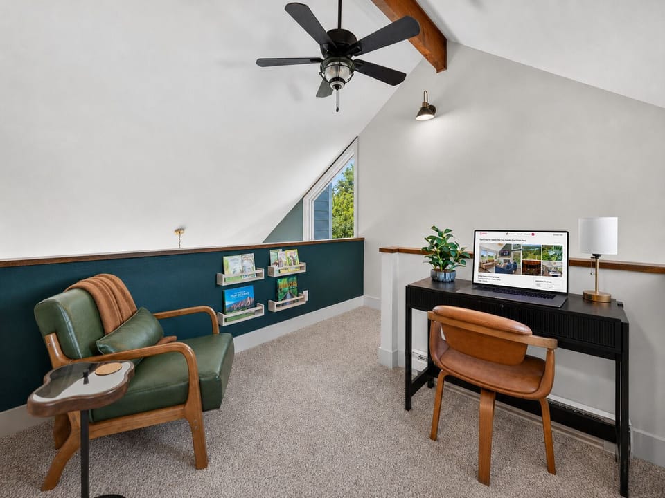 Quiet loft workspace with a desk, comfortable chair, and high-speed Wi-Fi for working remotely.