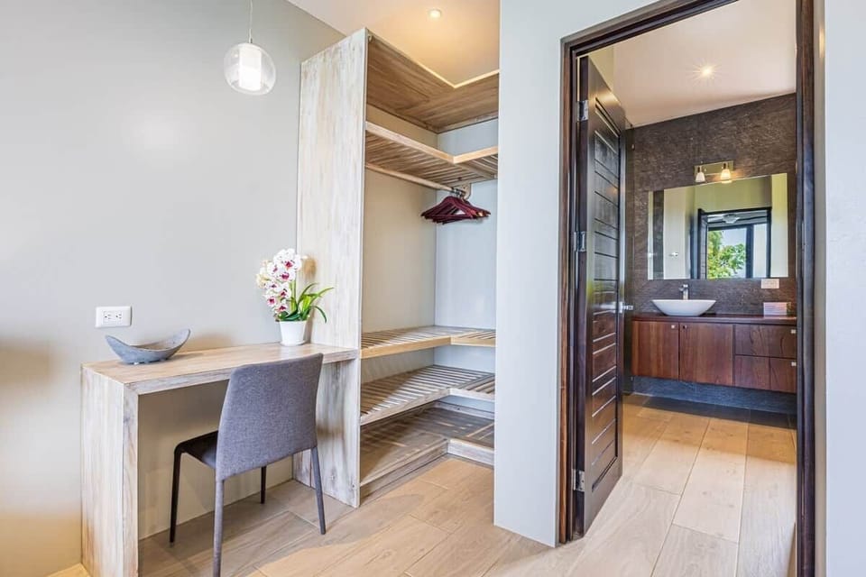 Master Bedroom closet, small desk and bathroom.