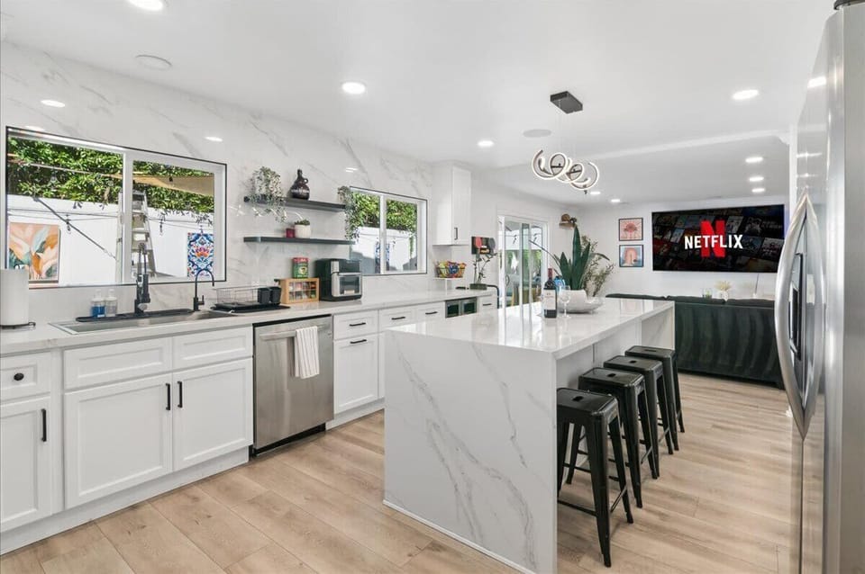 Modern and open kitchen with beautiful granite counters, stainless steel appliances, and high-end finishes throughout