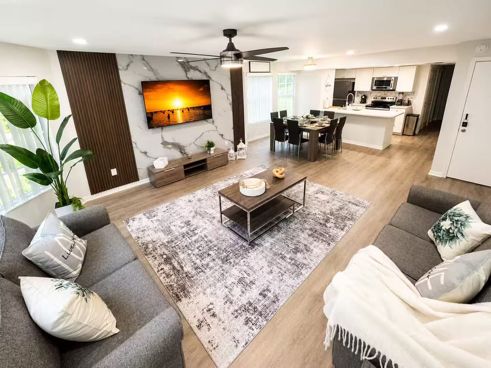 Spacious open-concept living area with comfortable seating and a TV.