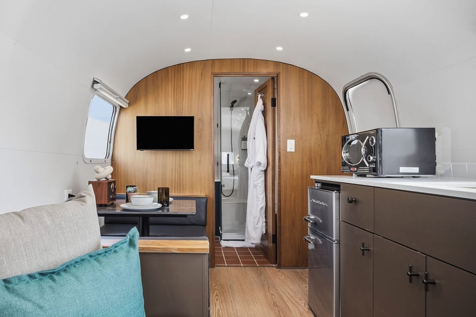 A sleek kitchenette with a fridge, prep space, and the essentials for easy mornings and simple nights in. Perfect for coffee, snacks, and reheating leftovers after a day out.