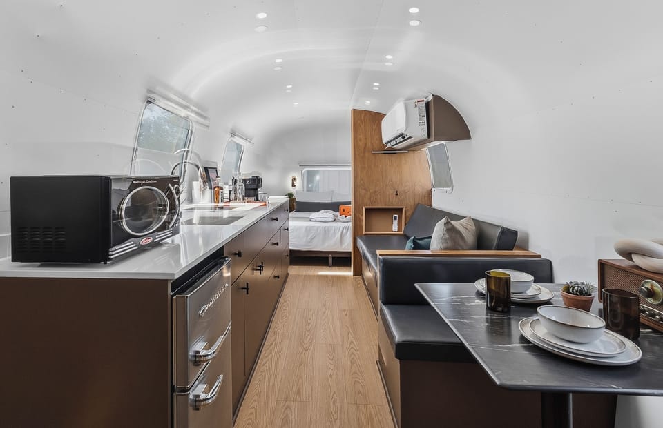 A sleek kitchenette with a fridge, prep space, and the essentials for easy mornings and simple nights in. Perfect for coffee, snacks, and reheating leftovers after a day out.