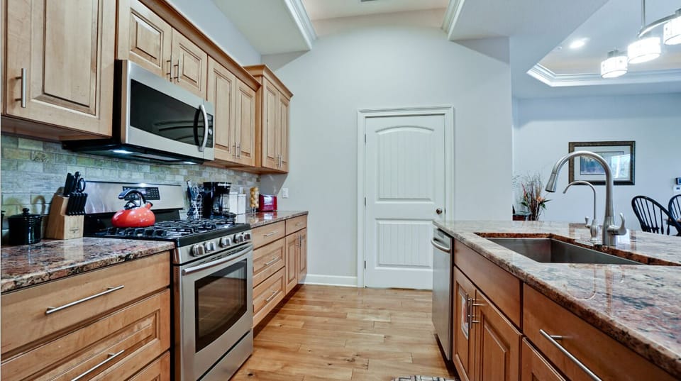 Spacious gourmet kitchen with granite counters and stainless appliances