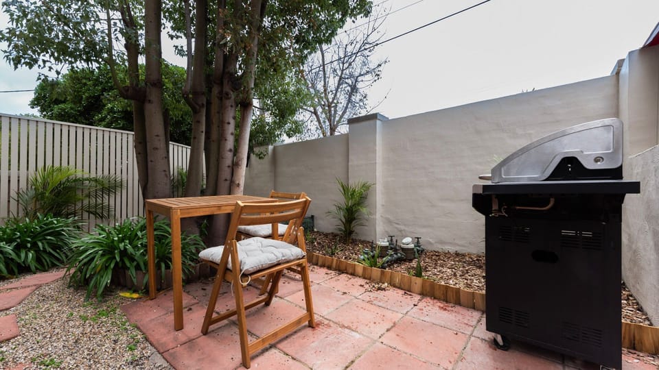 Private courtyard with BBQ and a peaceful outdoor dining space.