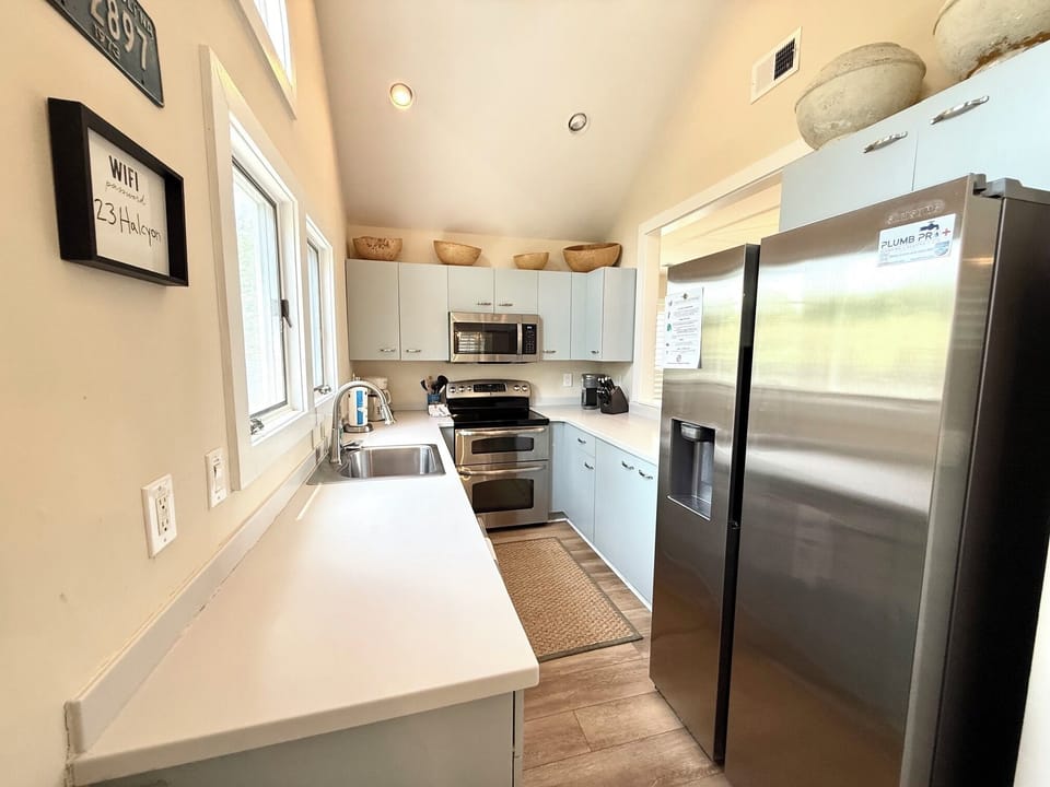 Well-stocked galley kitchen complete with sleek stainless steel appliances and ample counter space.