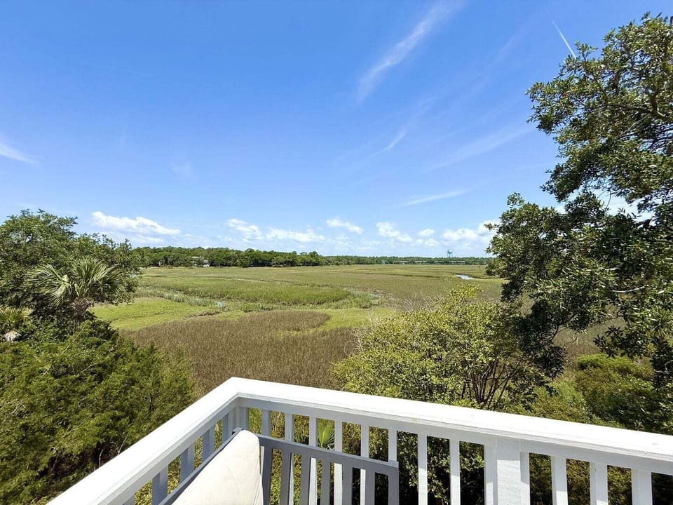 Unobstructed, panoramic views of the lush tidal marsh and creek from the top-floor deck.