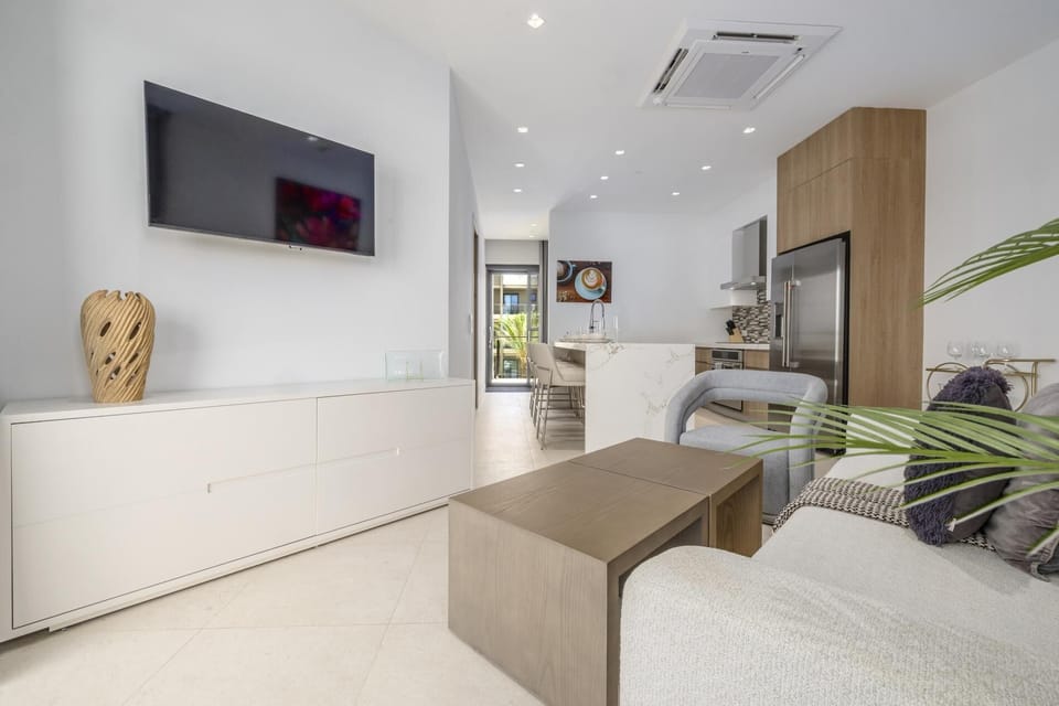 Open living room with a TV, easy access to the kitchen, and a comfortable setup for relaxing after a day out.