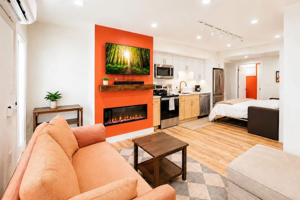 Bright modern studio with fireplace, kitchenette, and cozy open layout
