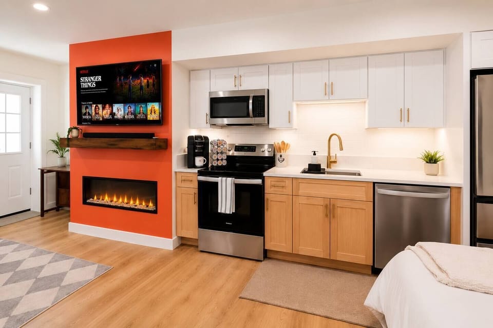 Fully equipped kitchen beside the cozy electric fireplace.