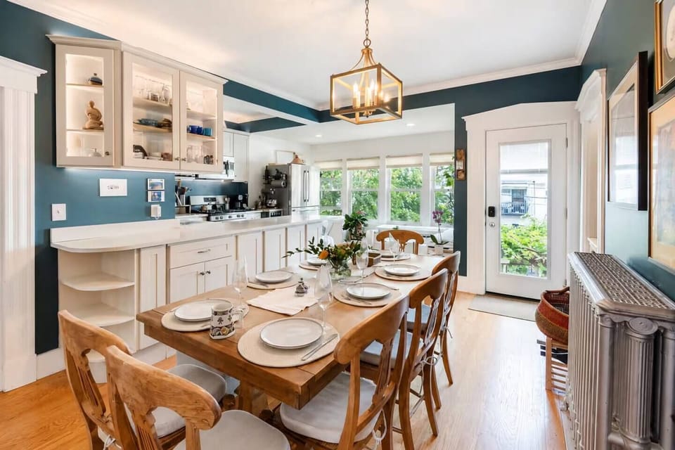The fully equipped kitchen includes sharp knives, quality cookware, a stand mixer, toaster, and a refrigerator with a built-in water dispenser. Overlooking the dining area, it's perfect for cooking while chatting with family and friends.