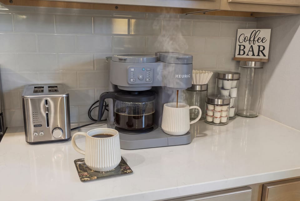 Skip the drive - the coffee bar has a maker, mugs, and a toaster ready to go.