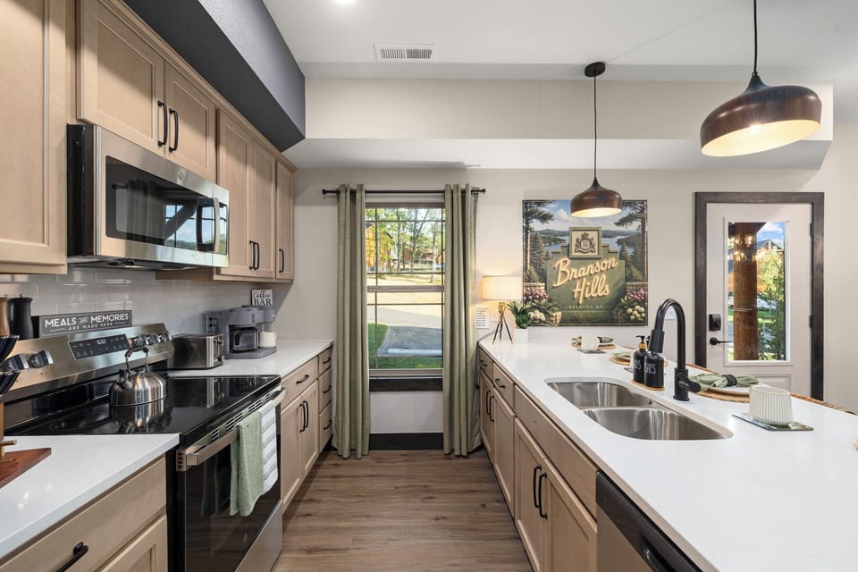 Bright quartz counters, stainless appliances, and room for a big group to cook.