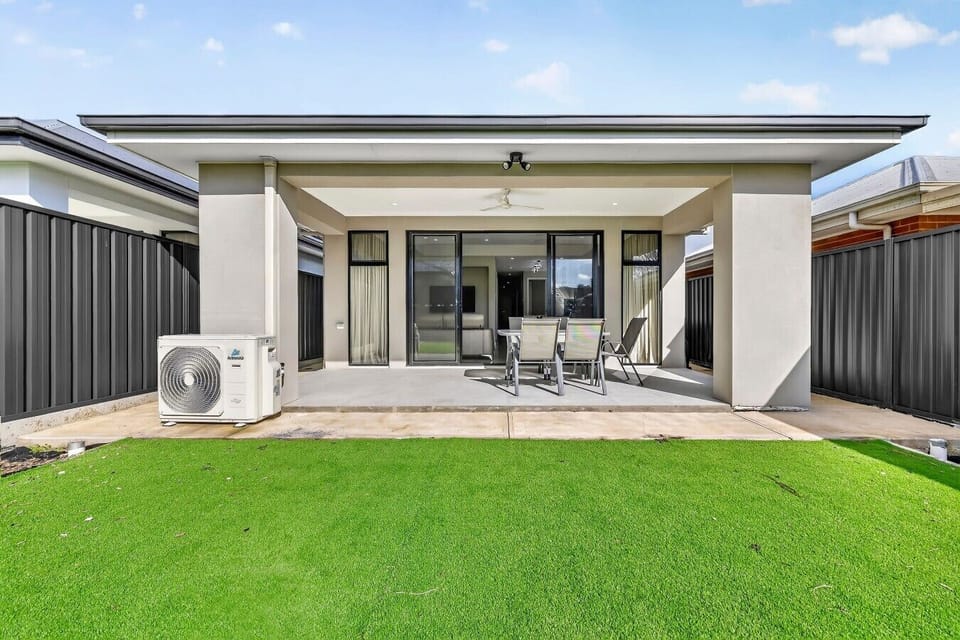 Sunny undercover patio opening onto a lush lawn