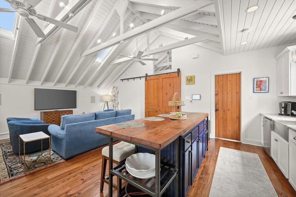 From the cozy blue seating to the colorful rug accents, every detail creates a warm and inviting atmosphere