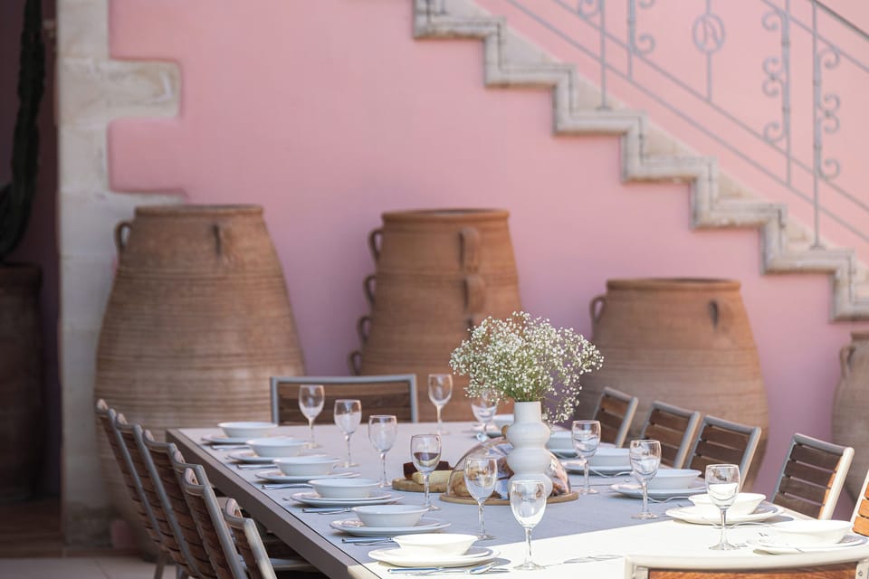 Long lunches unfold beneath pergola shade beside the manor’s private pool.