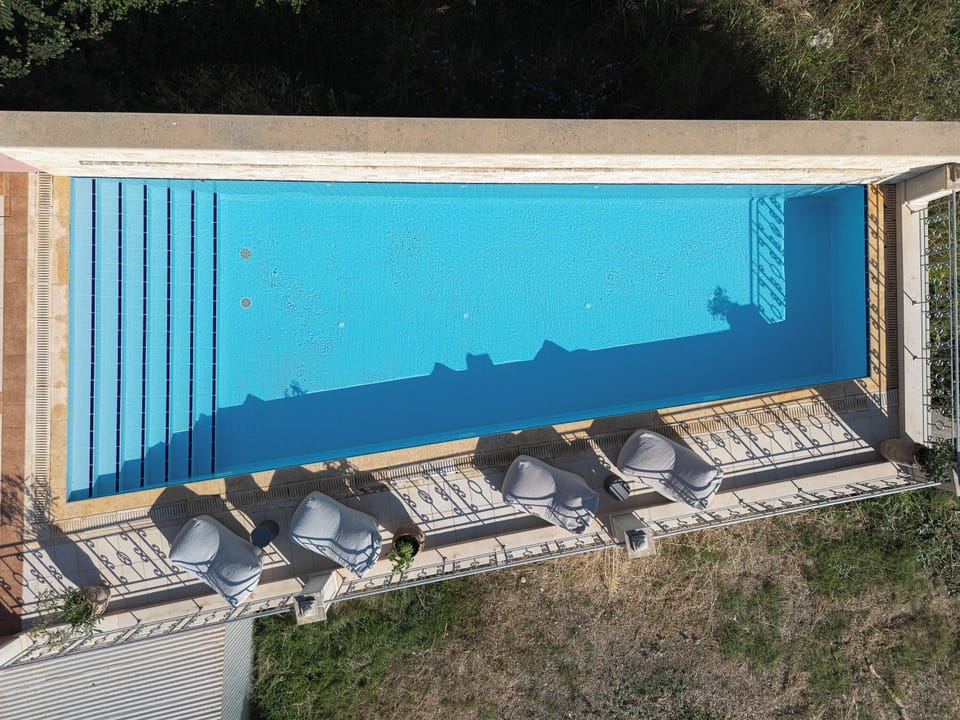 Relax by the pool beneath the Mediterranean sun.