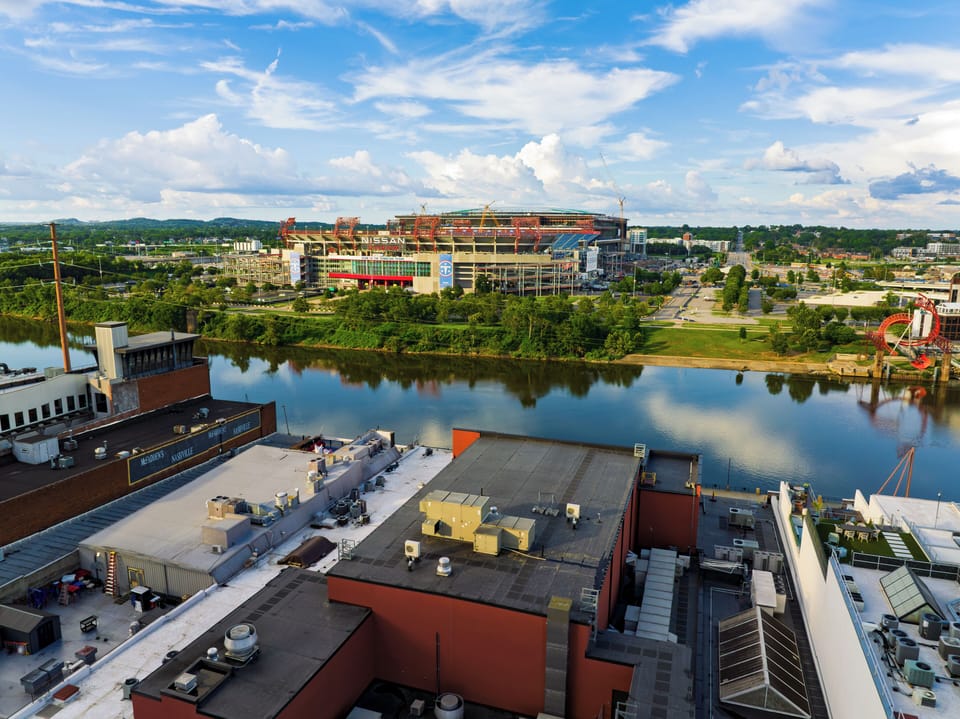 Aerial view across the river toward Nissan Stadium—an easy 16-minute scenic walk.