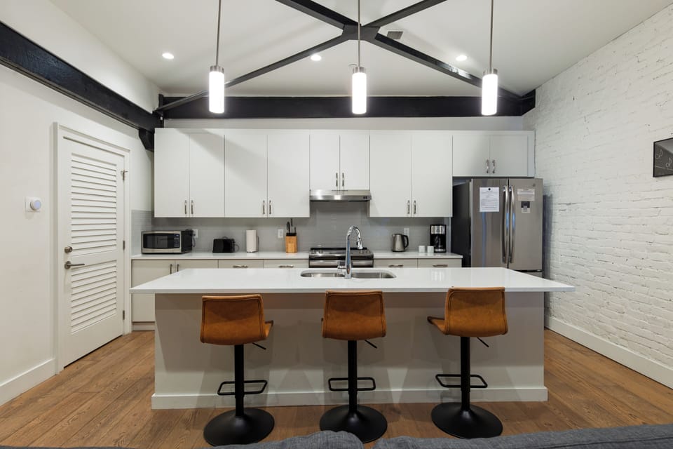The modern layout keeps everyone in on the conversation, seamlessly connecting the kitchen to the living room.