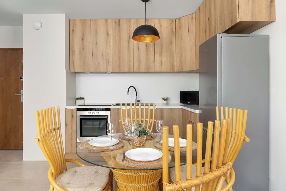 An open-plan kitchenette with a dining area. The layout offers a comfortable space for shared meals.