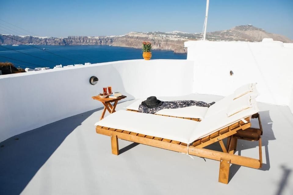 Private sun terrace with loungers and panoramic caldera views